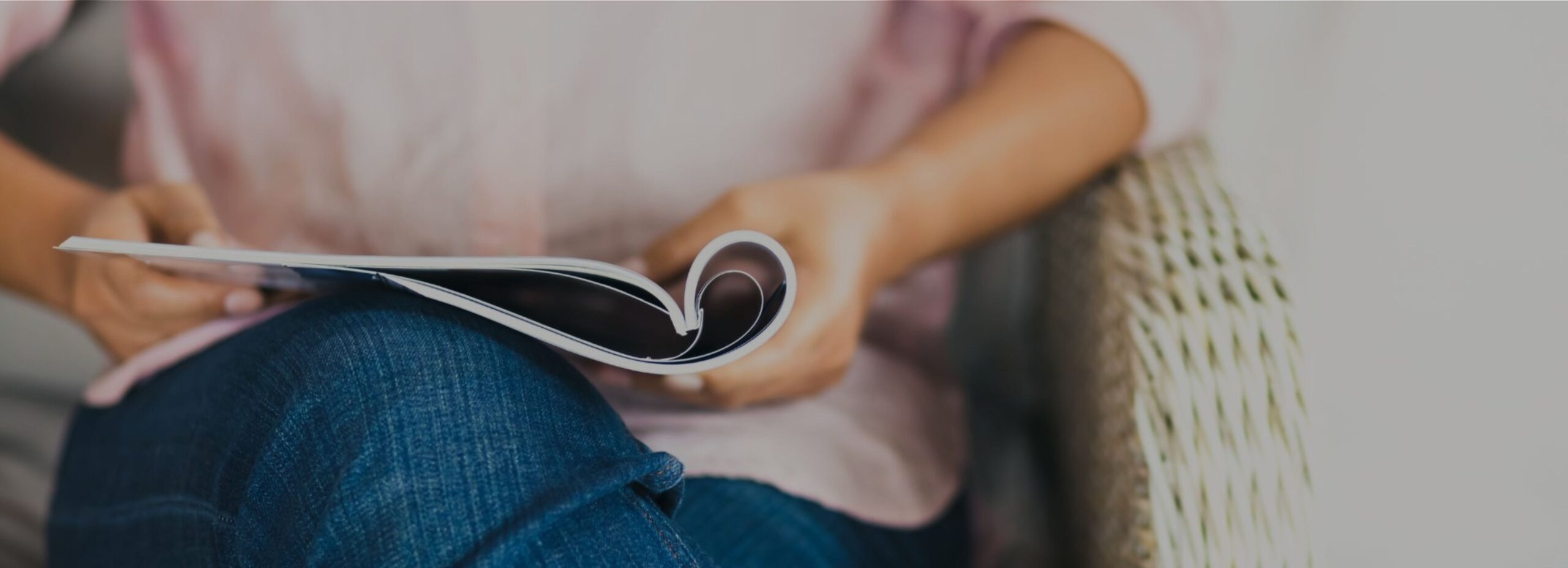 Someone holding a magazine in their lap